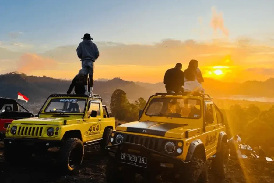 Two couples enjoying the sunrise from a jeep at the top of Mount Batur in Kintamani, part of the Mount Batur Sunrise Jeep Tour – Black Lava Point Adventure by The Fun Trev